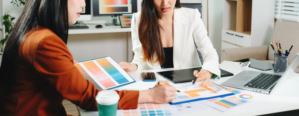 Two female designers collaborating on color palette and UX UI project